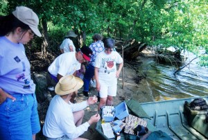 Citizen volunteers learn water sampling techniques on Mississippi River, 1998.